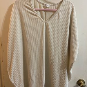 Plus size cream colored blouse.
